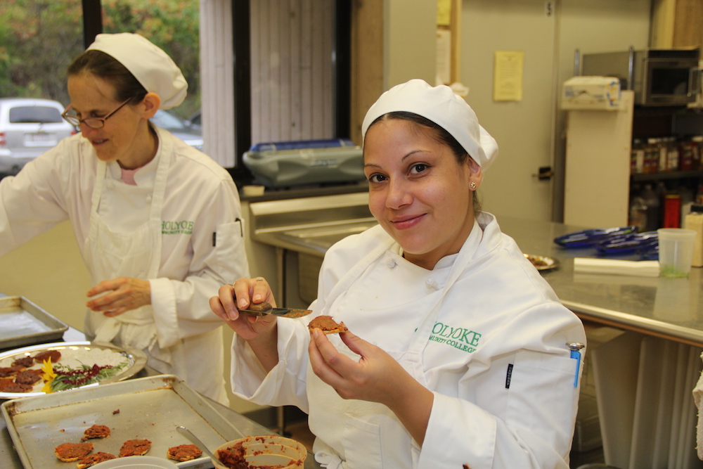A student prepares food for HCC's Sustainable Harvest Dinner